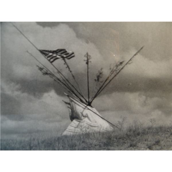 Large framed photo of Indian teepee with U.S. flag flying.