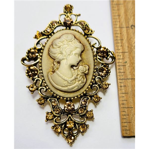 16)  BRONZE TONE WITH CREAM COLORED CAMEO