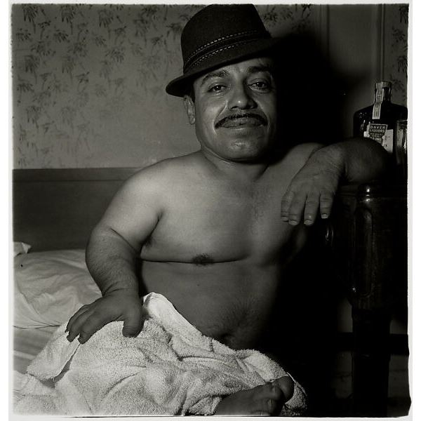 Photographer: Diane Arbus - Mexican dwarf in his hotel room in N.Y.C.
