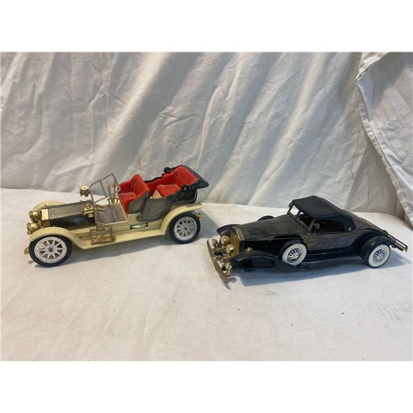 Two cars black one is missing front tires