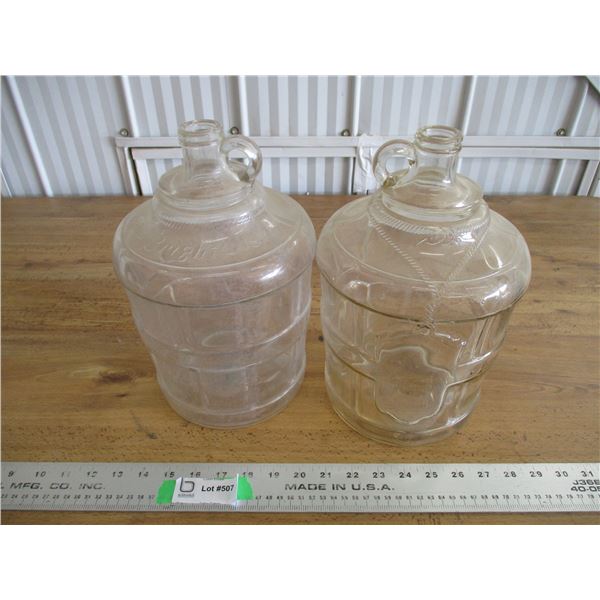 (2) Bright's glass ornate jugs
