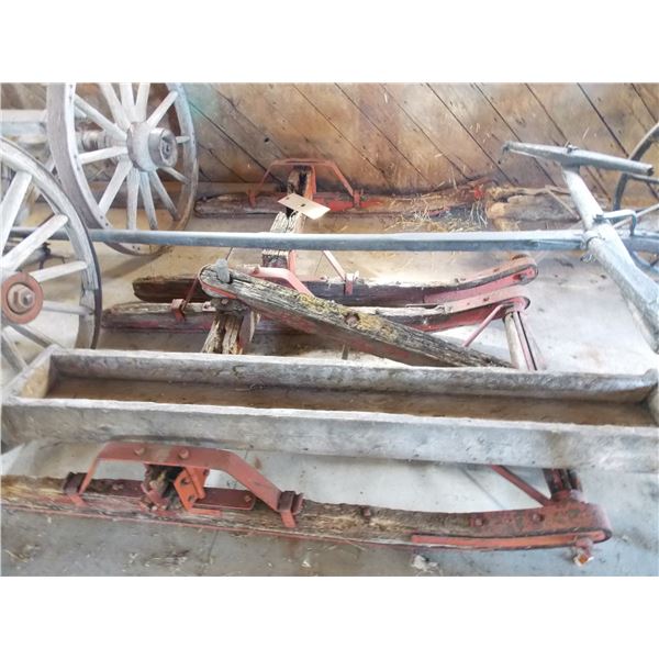 Two sleigh cart frames with wooden trough?