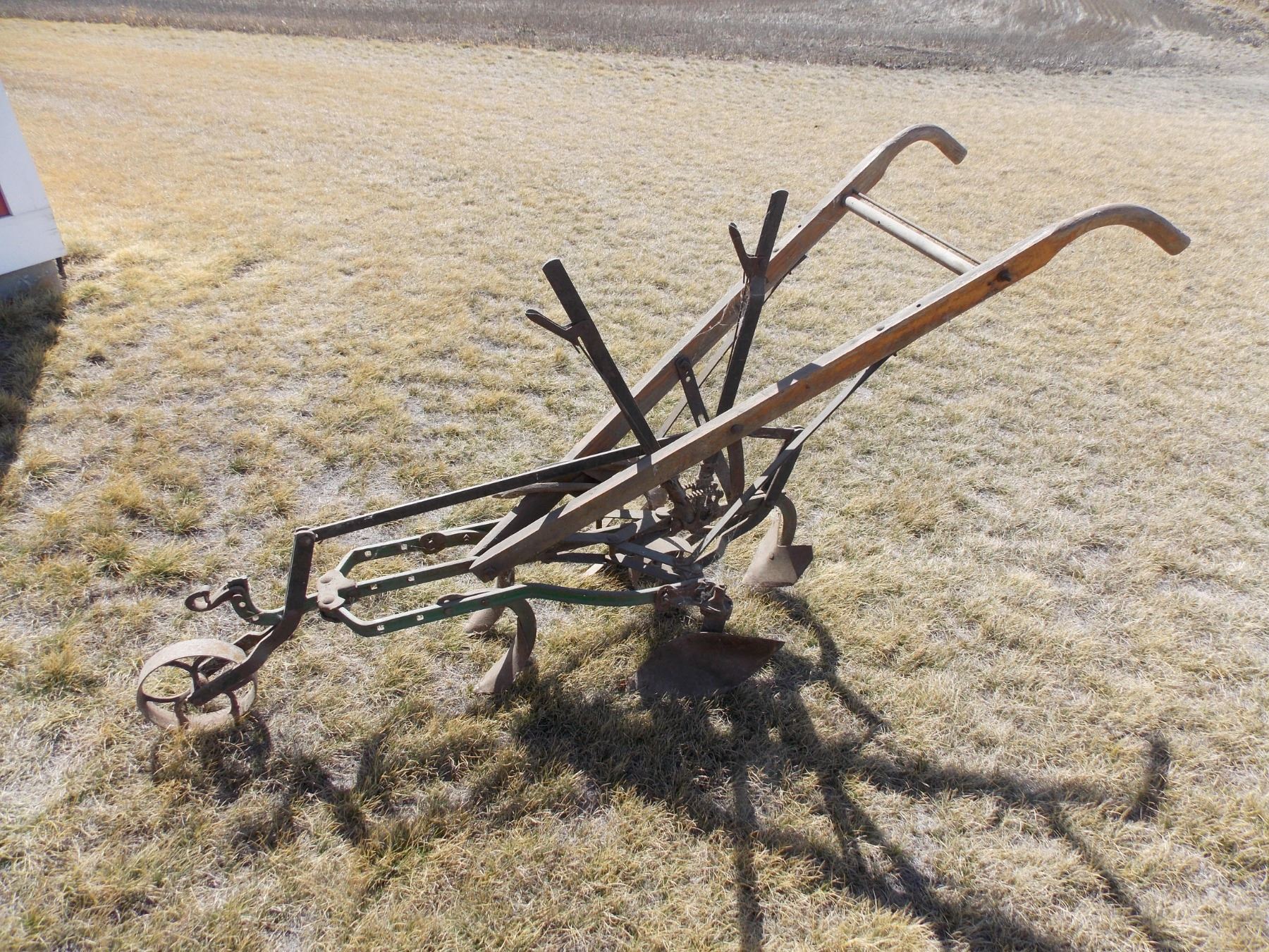 Antique hand plow wheeled