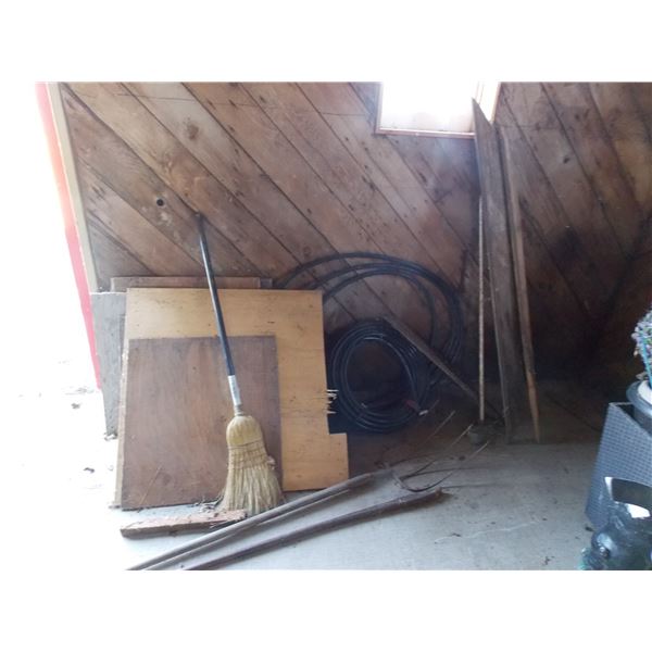 lot of plastic hose (3/4” rex polytube) wood pieces, prybar, broom, pitch fork