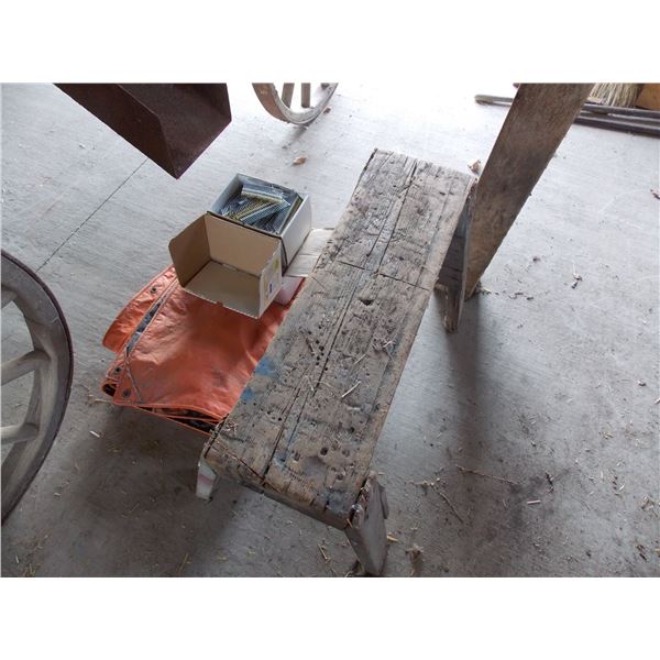 Saw horse, orange tarp, two boxes of strip nails