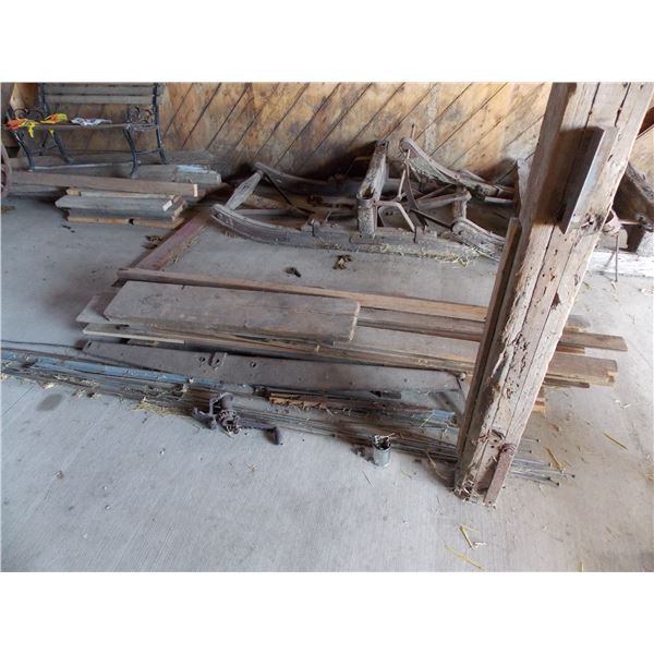 wood pile with metal parts – antique hand crank