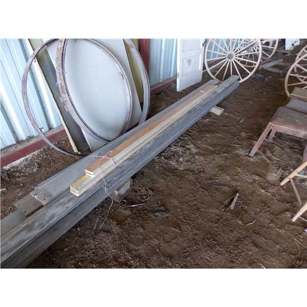 Pile of wood planks some 14 feet long Bodnarus Auctioneering