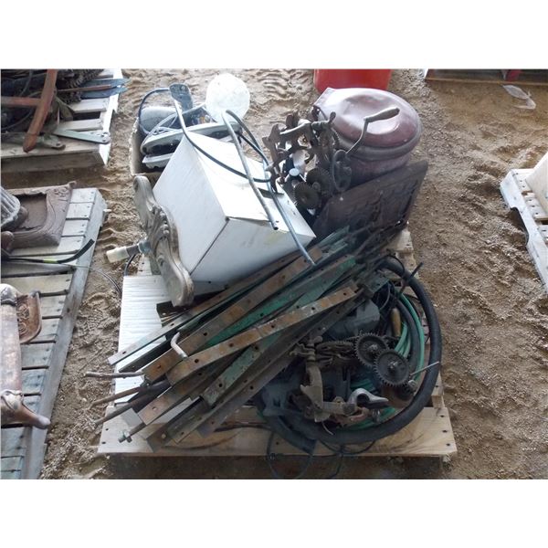 Pallet with cast iron vent, other antique parts, motor oil, hubcaps