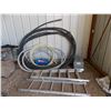 Image 1 : Lengths of hose, damaged ladder, animal trap, air tank