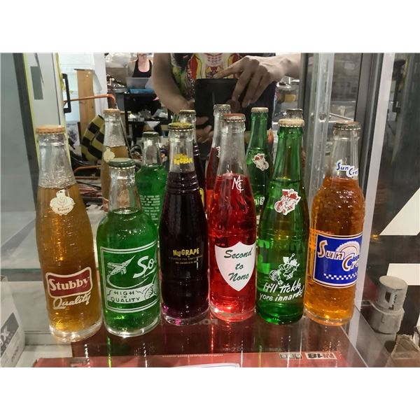 6 ASSORTED VINTAGE BOTTLES ALL FULL, BRANDS INCLUDE; STUBBY, SUNCREST, MOUNTAIN DEW, NUGRAPE, AND