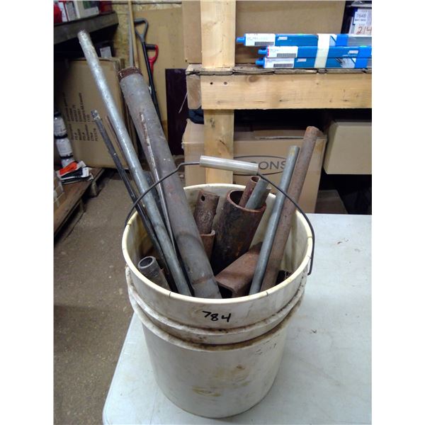 Bucket of Metal Pipes and Rods