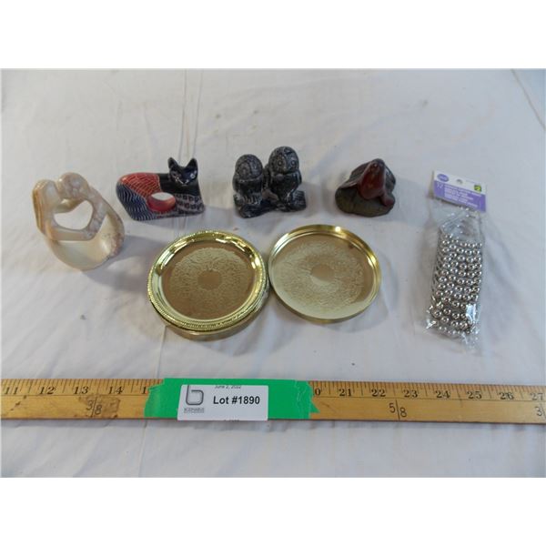 Golden coasters and stone figurines