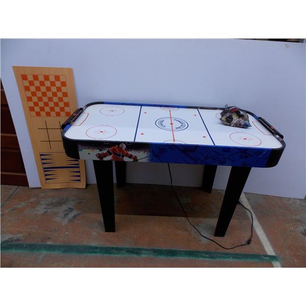 * Air hockey table with other games mat and pieces