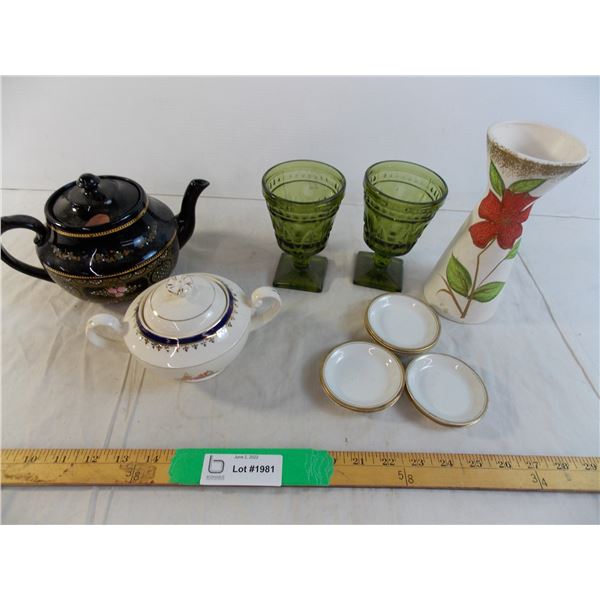 Teacup and sugar dish with other various dishes