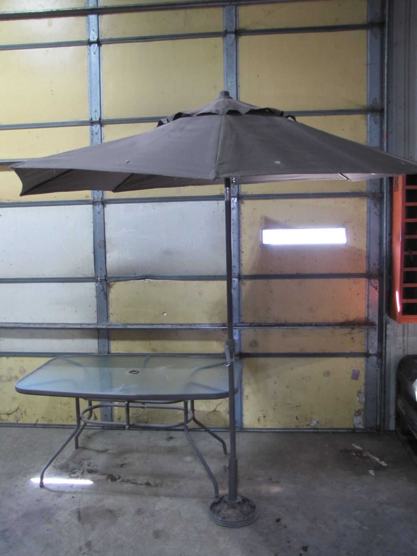 Patio table with four chairs and umbrella