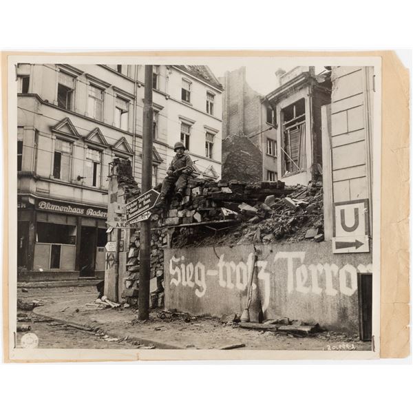 US SOLDIER ON TOP OF GERMAN RUBBLE