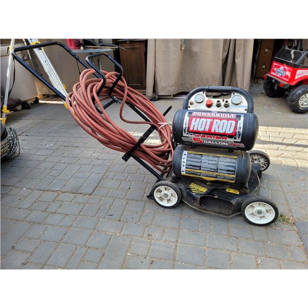 5 Gallon Air Compressor with hose carrier, mounted on a lawn mower chassis for easy moving.