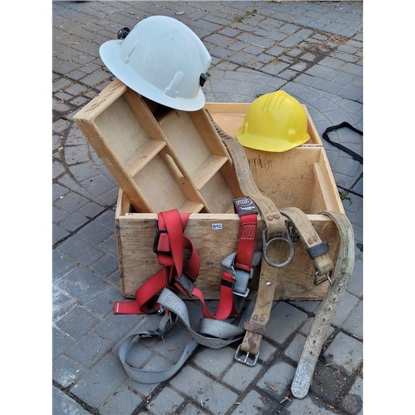 Large wood tool box with safety harness, straps & helmets.