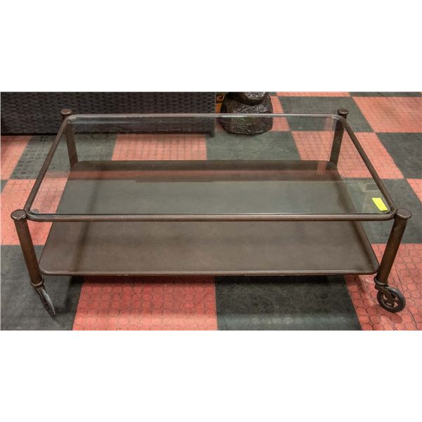 METAL/GLASS COFFEE TABLE ON CASTORS 47  X 29  X 18