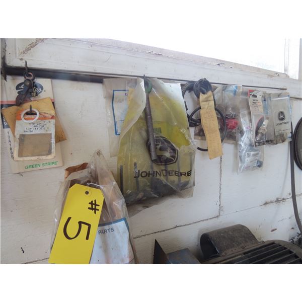 JOHN DEERE PARTS & GRINDING DISCS (ON WALL)