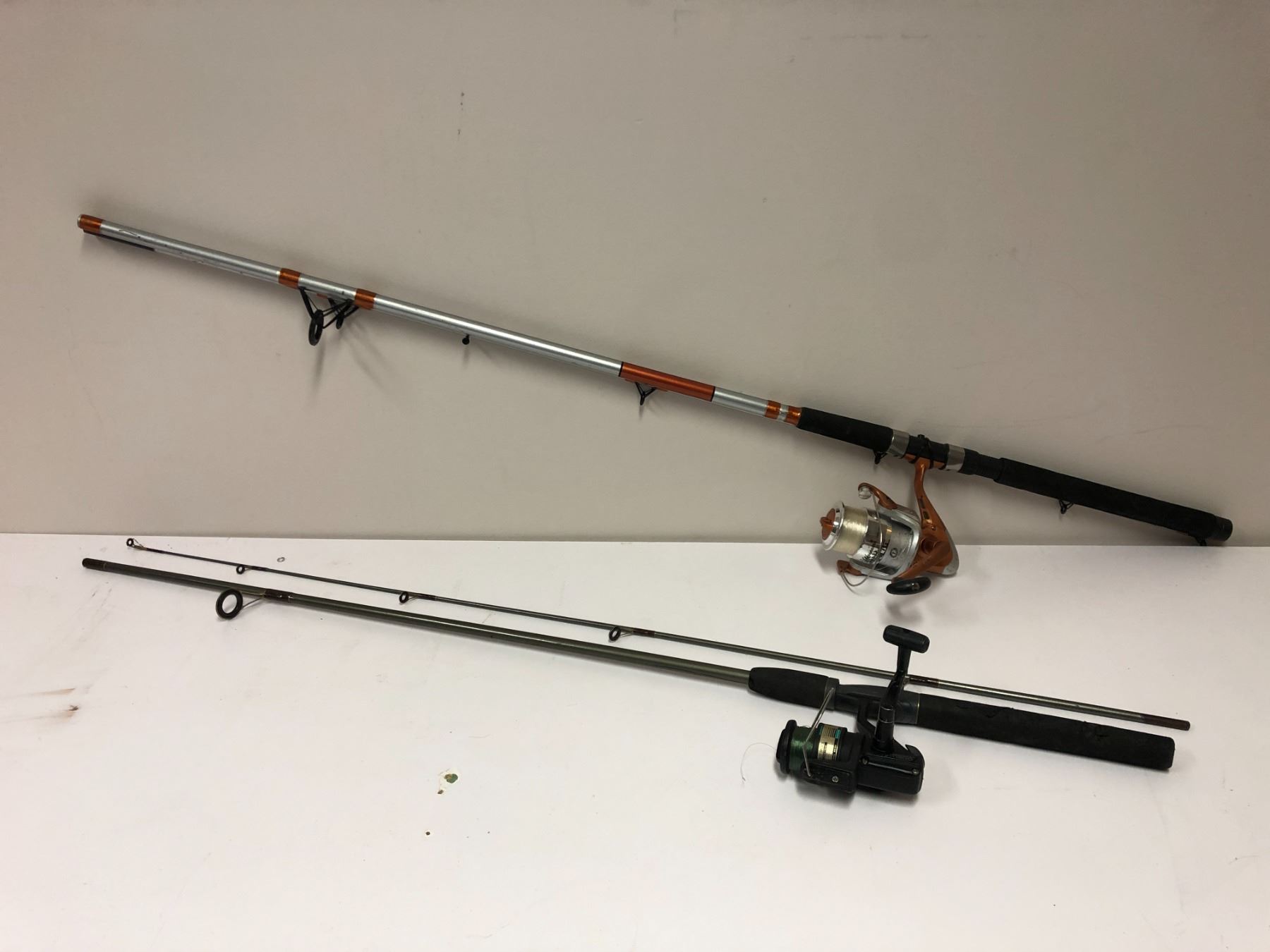 2 fishing rods w/ spinning reels