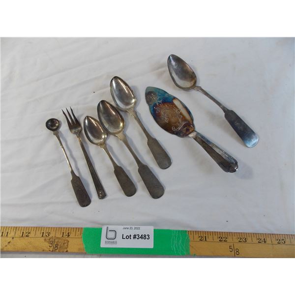 Silver serving spoons and forks