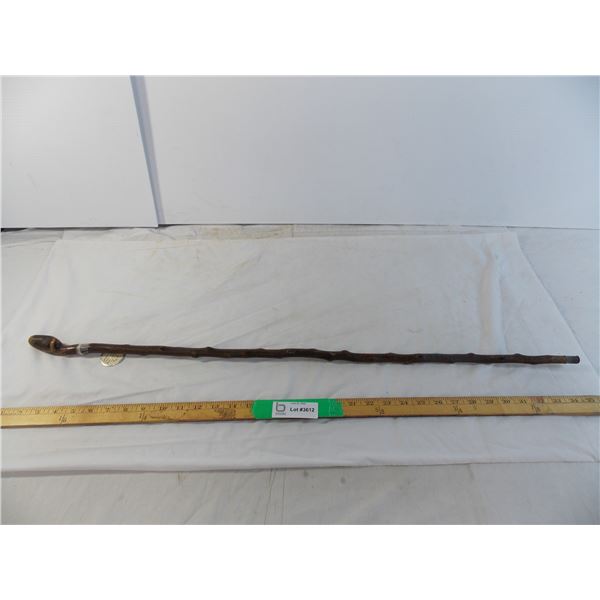 Walking cane tipped with brass shell casing