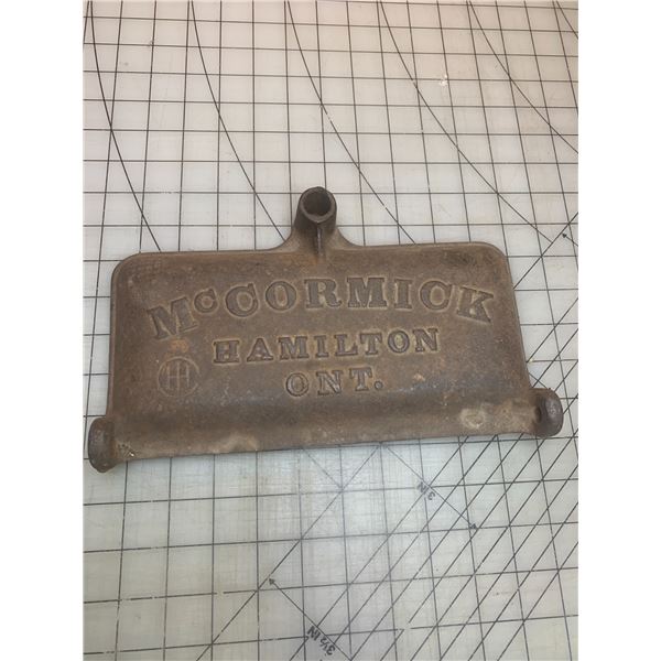 ANTIQUE CAST IRON MCCORMICK IMPLIMENT LID