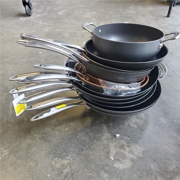 STACK OF DEFECTIVE STORE RETURN WOKS AND PANS