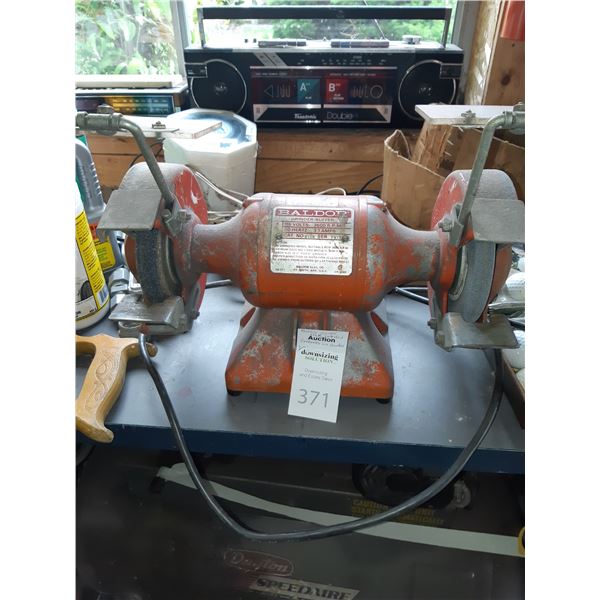 Baldor grinder buffer and contents on counter. Cat E