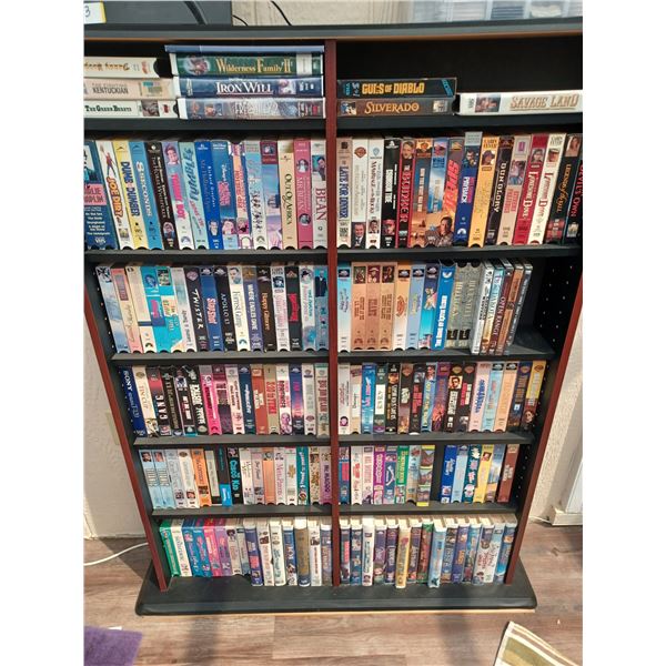 150+/- VHS AND DVDS - COMES WITH SHELVING UNIT. PLEASE SEE IMAGES FOR MORE INFO