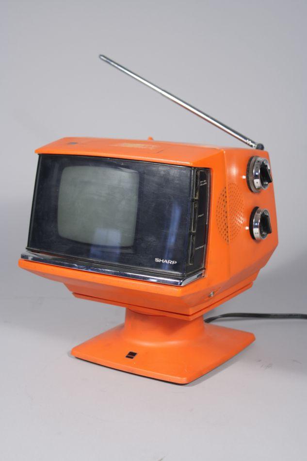 A MidCentury Sharp AA 101R Orange Television with Stand.