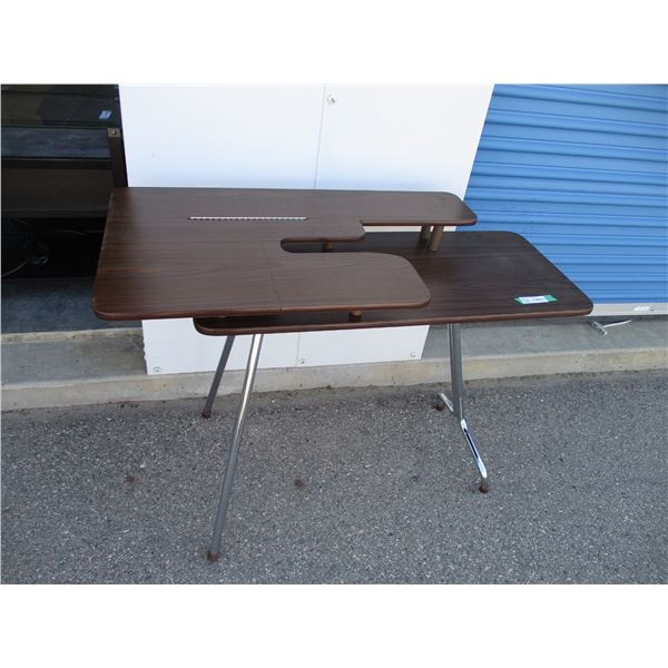 Sewing table with folding legs