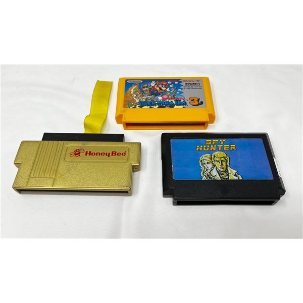 lLt of 2 nintendo game cartridges and adaptor