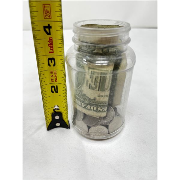 Jar of mixed coins and banknotes from USA/Canada