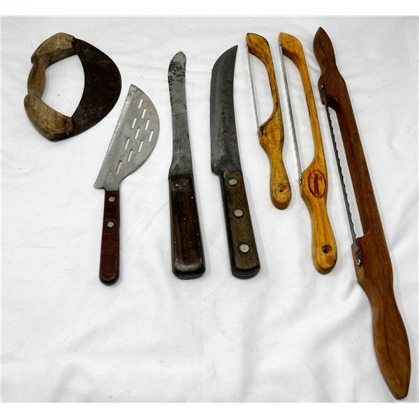 Wooden kitchen tools including saws and knives