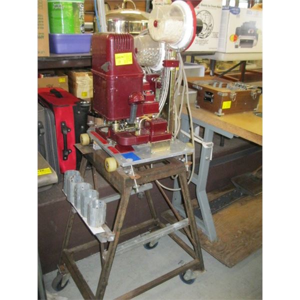 GROMMET MACHINE ON METAL ROLLING STAND