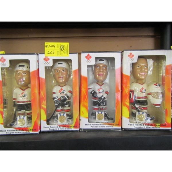 FOUR HAND PAINTED BOBBLE HEAD HOCKEY FIGURINES