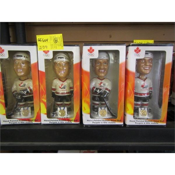 FOUR PAINTED BOBBLE HEAD HOCKEY FIGURINES