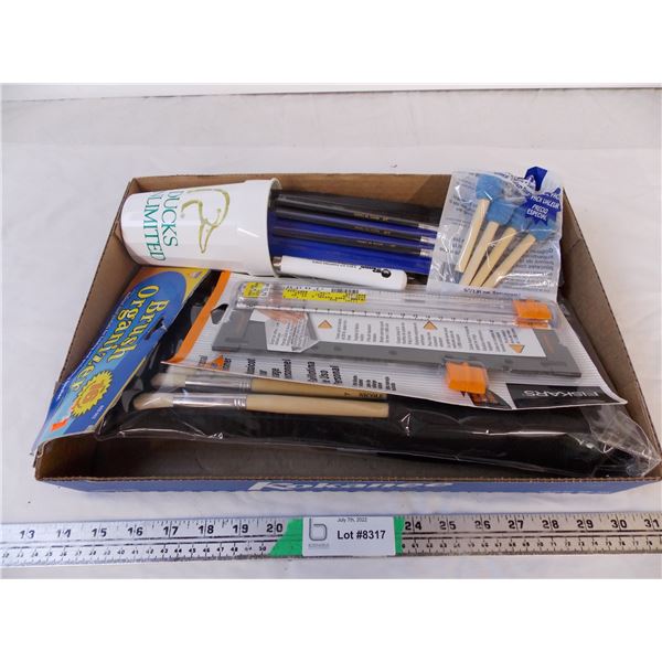 box of paint brushes and painting accessories