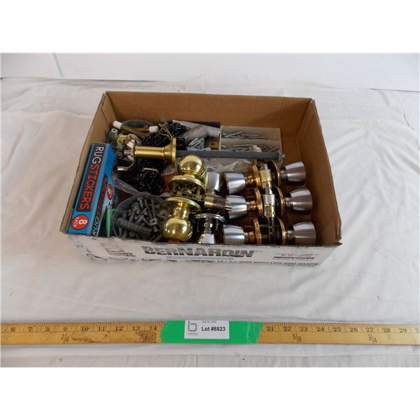 Assorted door handles and knobs with parts and accessories for installing