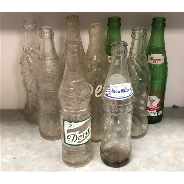 Group of 9 antique beverage bottles