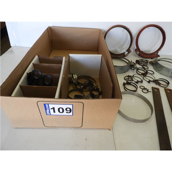 Various hose clamps, gaskets, tarp strap tie down bars, (1) large clamp 6", (1) large clamp 5"