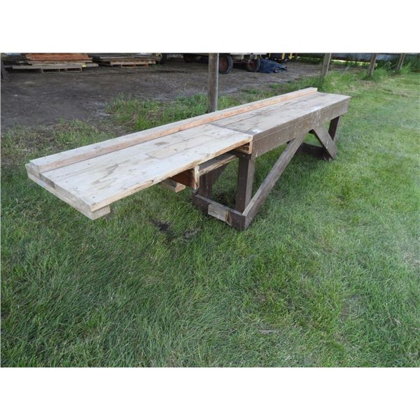 Wooden mitre saw table 13ft L x 22" W, 33" H, 4"x4" legs, 2" x 12" top boards, wooden scaffolding pl