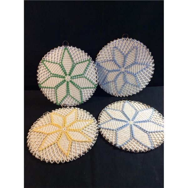 4  adorable handmade doilies over top of hot plates