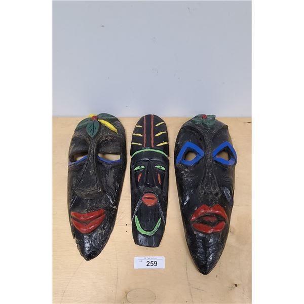 THREE WOOD HAND PAINTED AFRICAN STYLE MASKS