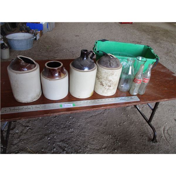 Basket with pop bottles, stone jugs (some missing pieces)