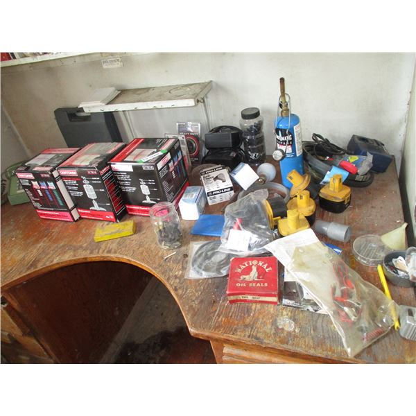 Contents of top of table - battery, torch, misc