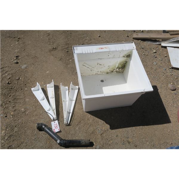 white 24" plastic wash sink with legs and pipe.