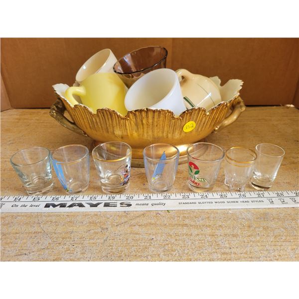 Gold colored oval porcelain dish stamped 'Italy' filled with glassware & shot glasses